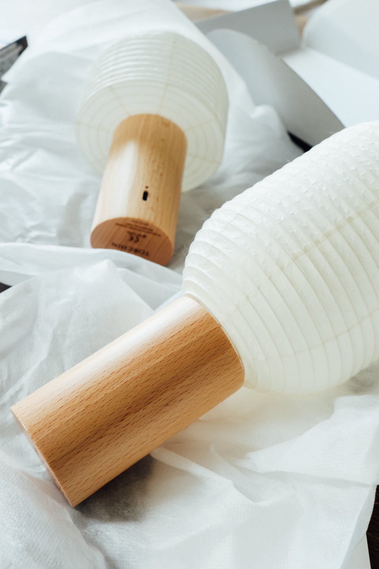 Détail d'une lampe TORCHIN, papier washi et socle en hêtre